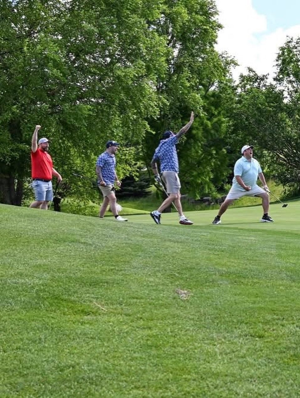 A group cheering from the fairway