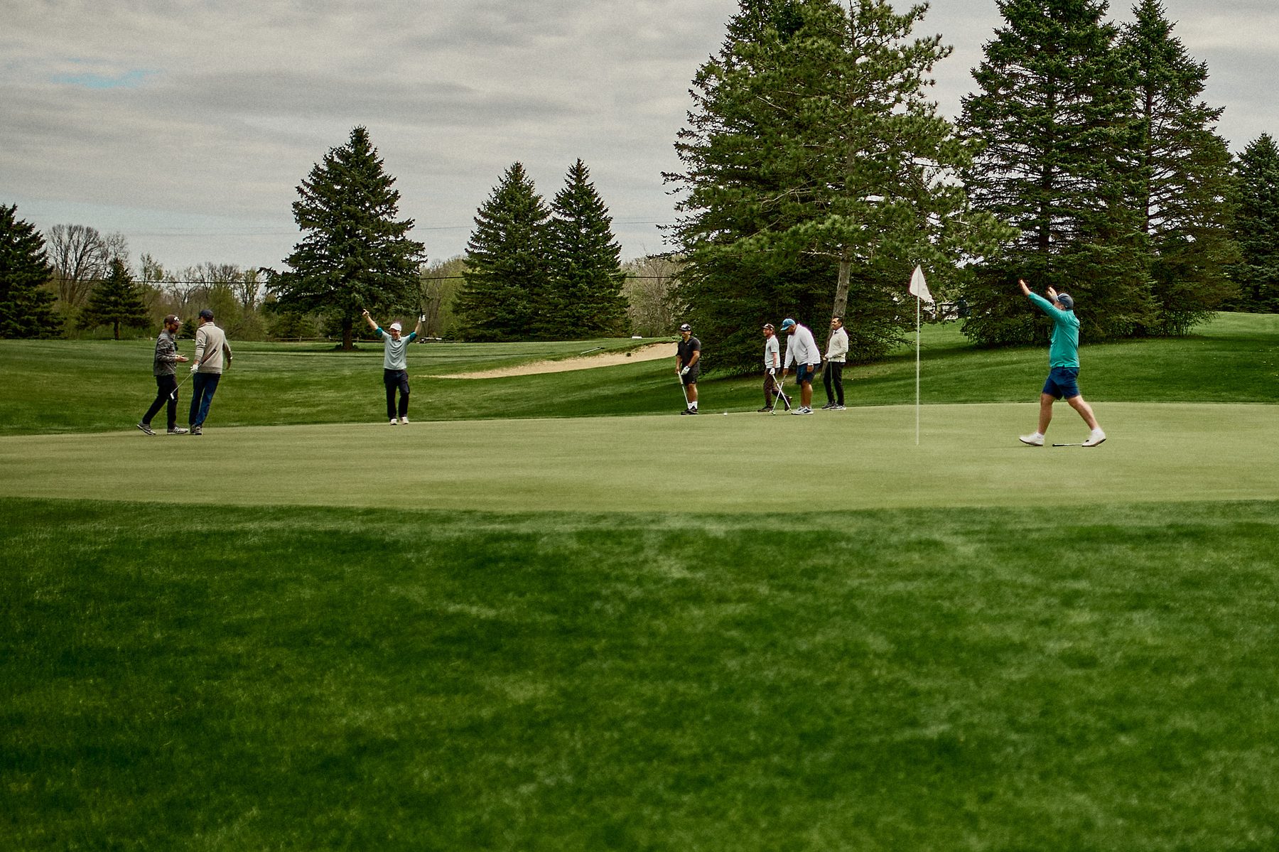 Players celebrating on the green